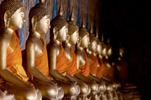 Golden buddha statues inside a Thai temple.